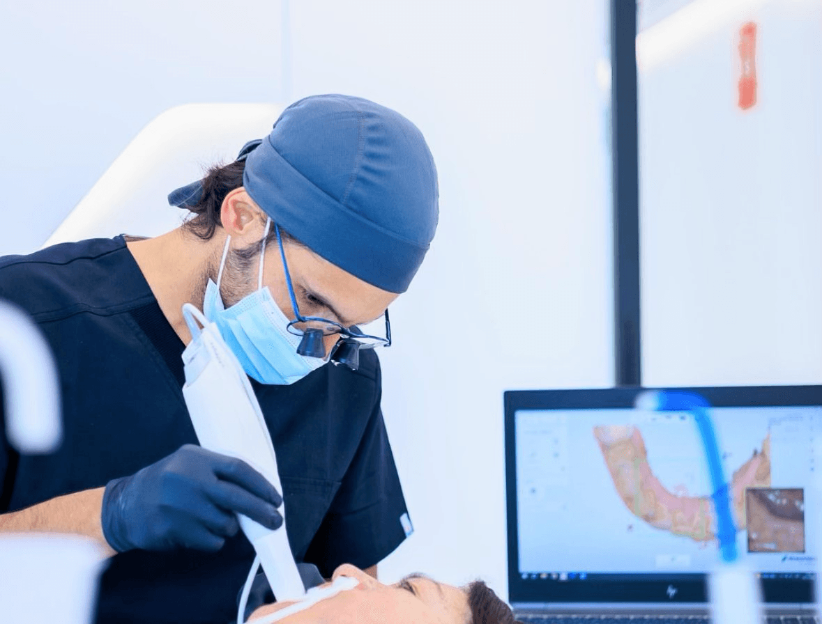 Perfect Smiles dentist using digital scanning equipment during treatment
